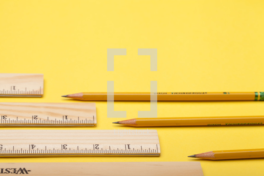 pencils and rulers on a yellow background 