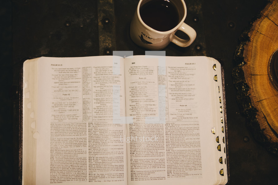 An open Bible and a coffee mug. 