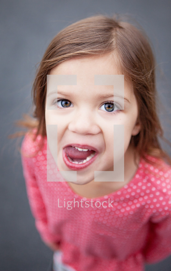 girl child sticking her tongue out 