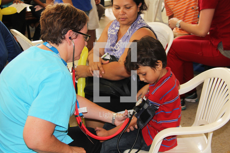children receiving medical care from a doctor at a missions clinic