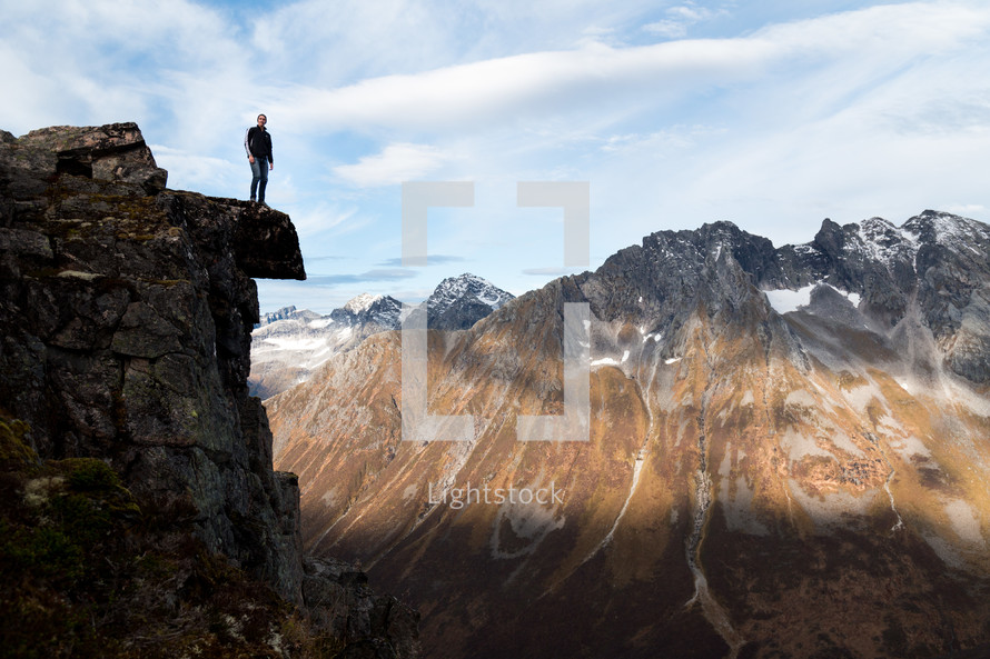 a man standing at the edge of a cliff 