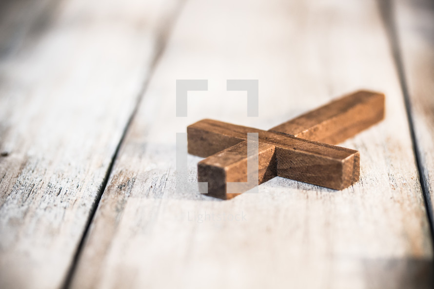 wooden cross on wood boards 