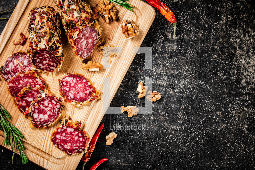 Delicious salami sausage on the table. On a black background. High quality photo