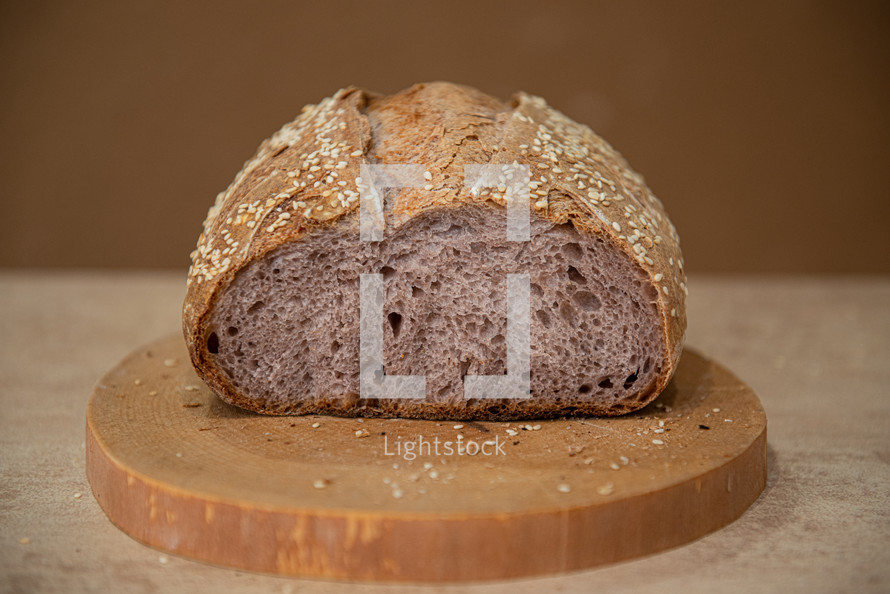 unusual craft bread with lilac-colored pulp on a brown background with copy space