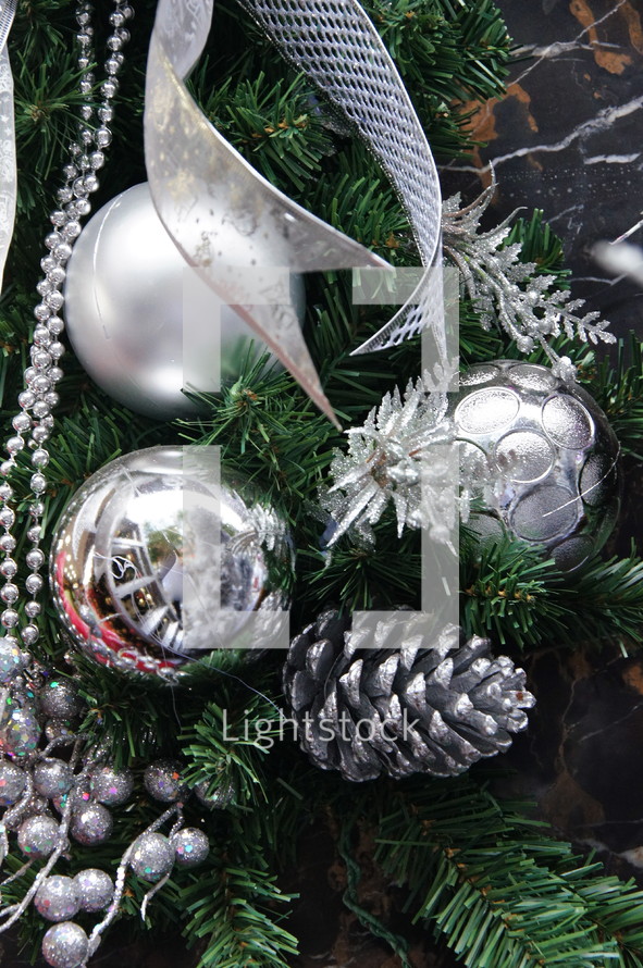 silver Christmas ornaments on a Christmas tree