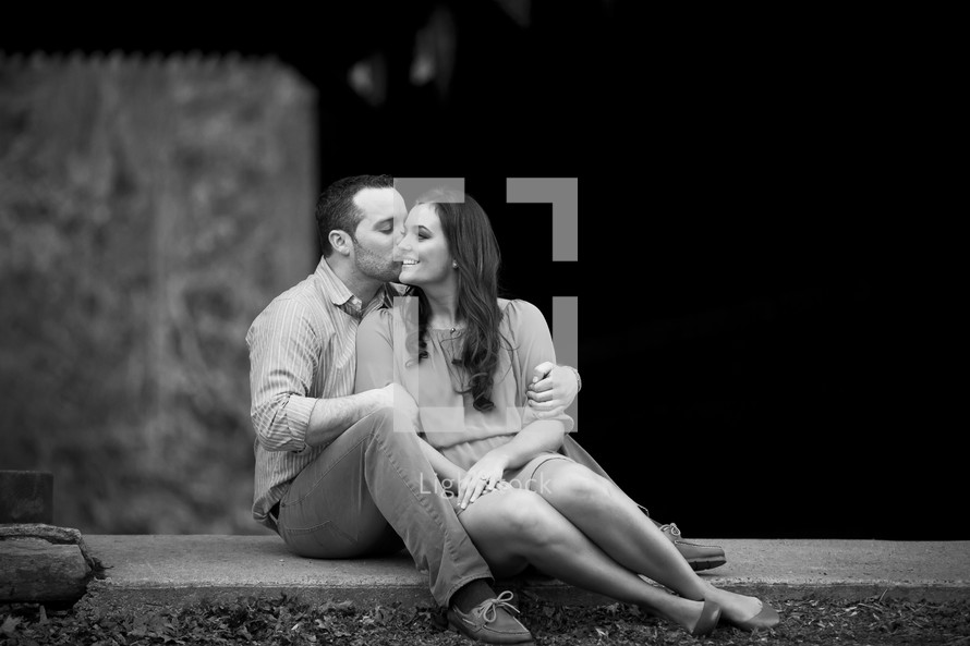 man kissing a woman on the cheek 