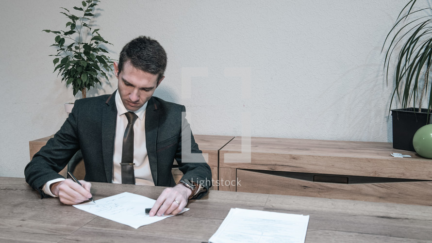 man signing a document 