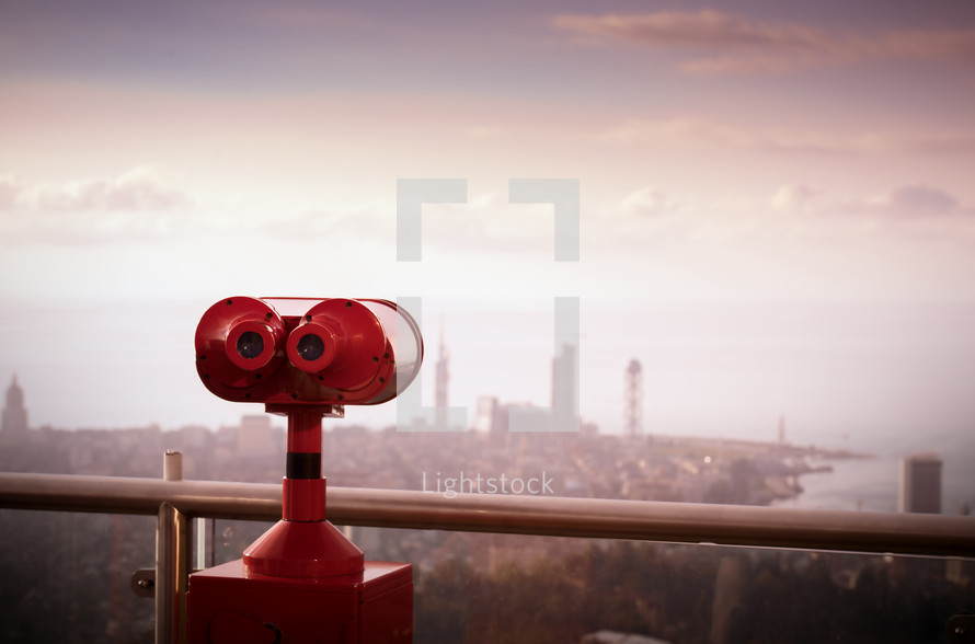 red viewfinder scope facing a city 