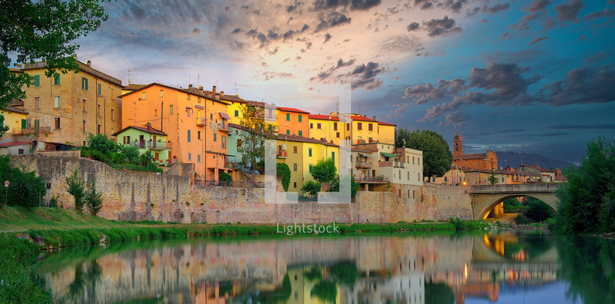Old italian city Umbertide near Tevere river with cloudy sunset light