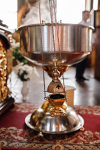 selective focus. A priest's censer hangs on an old wall in the Orthodox Church. Copper incense with burning coal inside. Service in the concept of the Orthodox Church. Adoration