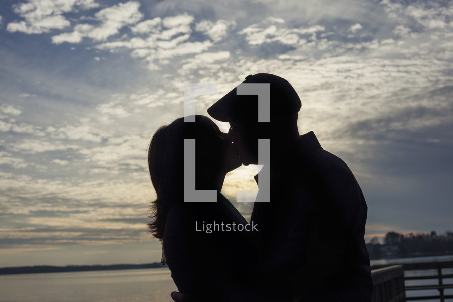 silhouette of a couple kissing 