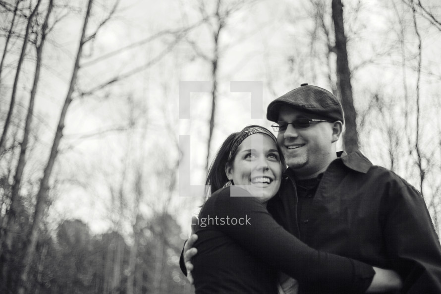 man and woman hugging outdoors