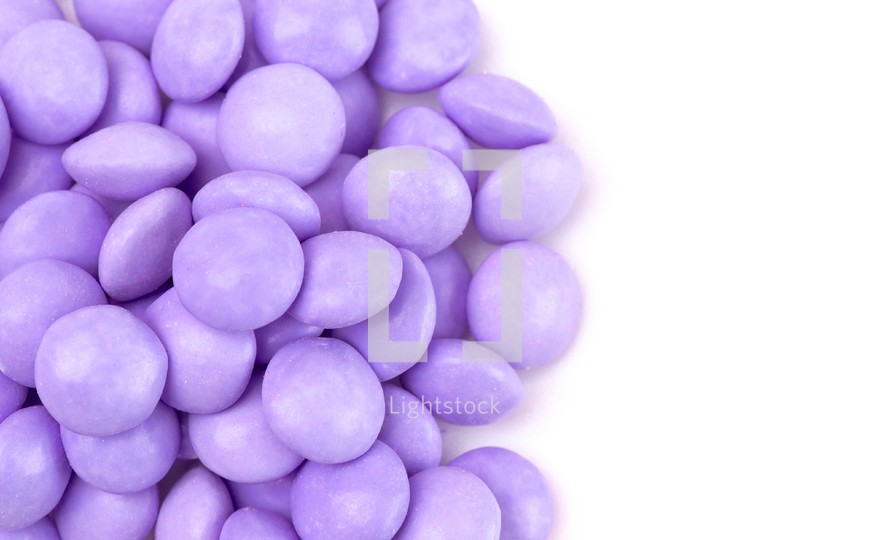 Pile of Candy Coated Chocolate Gems on a White Background