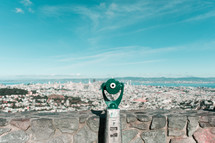 viewfinder scope overlooking a coastal city 