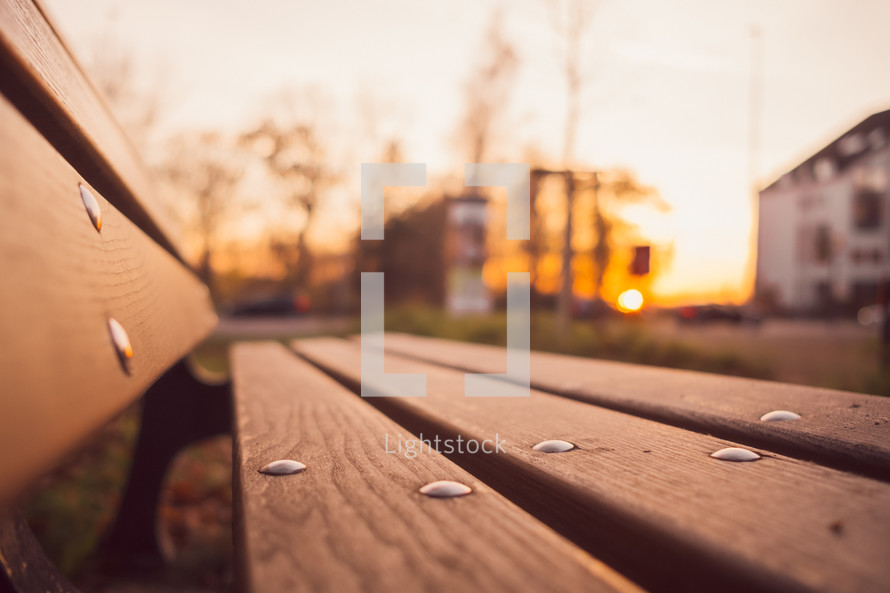 empty park bench at sunset 