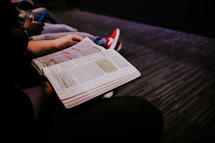 man with a Bible in his lap at church 