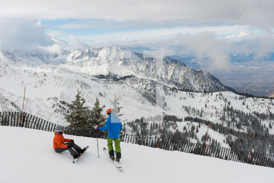 skiers at the top of a slope
