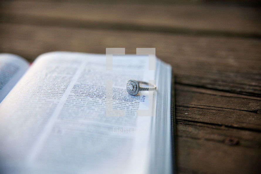 engagement ring on the pages of a Bible