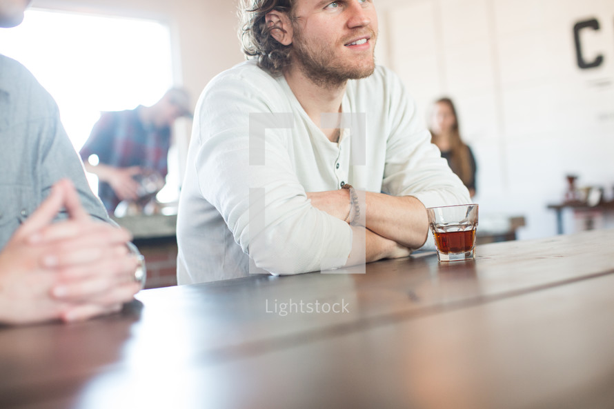 man sitting at a bar table at a coffee shop 