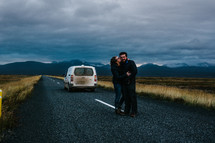 a couple kissing in the middle of a road in Iceland 