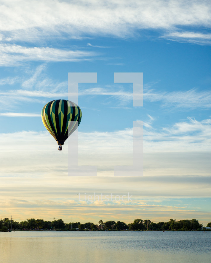 hot air balloon over a lake 