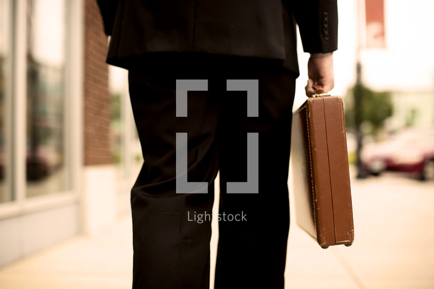 man walking carrying a briefcase 