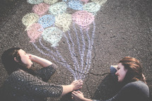 holding chalk balloons 