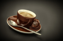 spoon on a saucer and coffee cup 