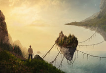 man looking out at a floating island suspended by vines 