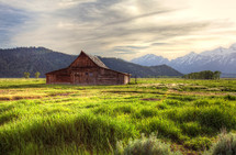 barn and snow capped mountains 