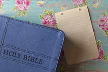 Bible and blank notebook paper 