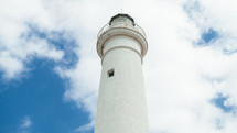 Lighthouse tower in daylight with clouds