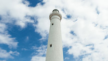 Lighthouse tower in daylight with clouds