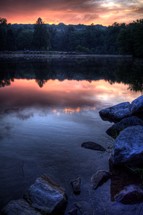 pink clouds reflecting in lake water at sunset
