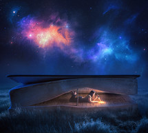 a woman reading in a Bible tent under the stars 