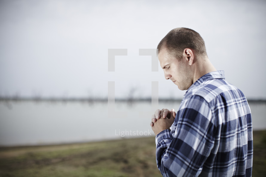 A man praying near water