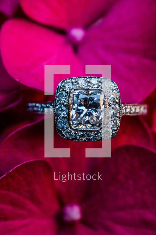 An engagement ring among purple red flowers square solitaire diamond wedding vintage platinum
