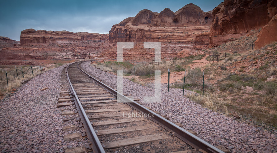 train tracks through red rock peaks 