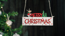Merry Christmas sign with tree on the background