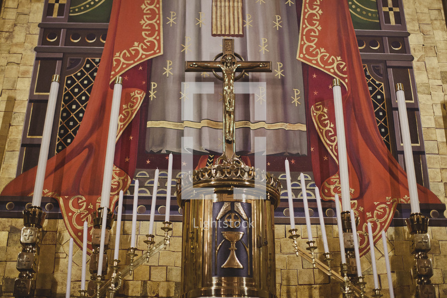 A holy altar with candelabras and a crucifix
