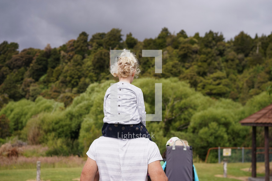 a daughter on father's shoulders 