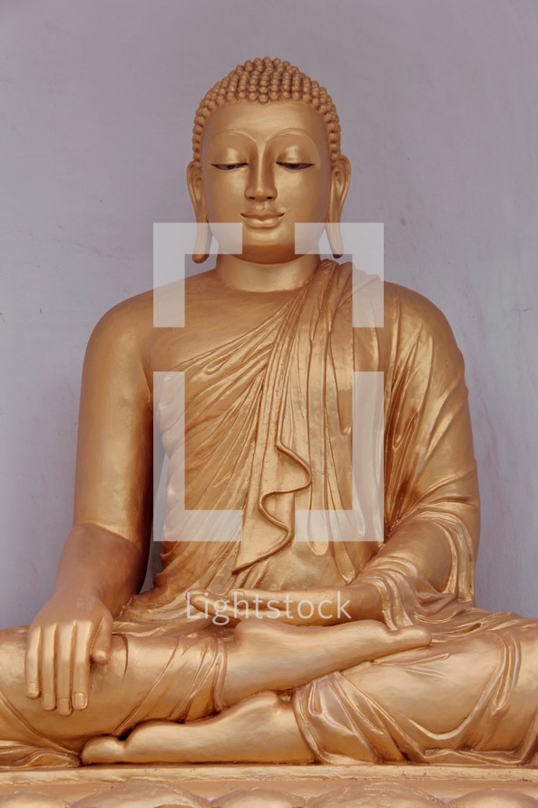 Golden Statue of Buddha seated in Lotus Position