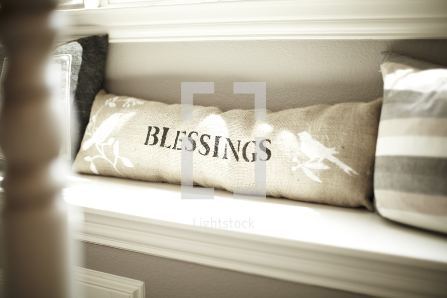 A pillow with the word blessings on it