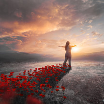 woman stands with her shadow forming a garden of red roses