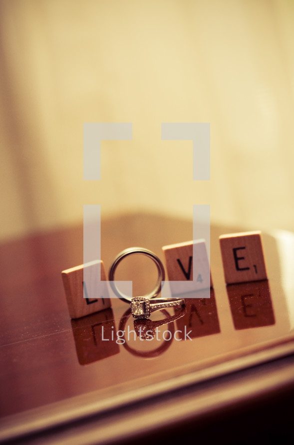 word LOVE in scrabble blocks and wedding rings