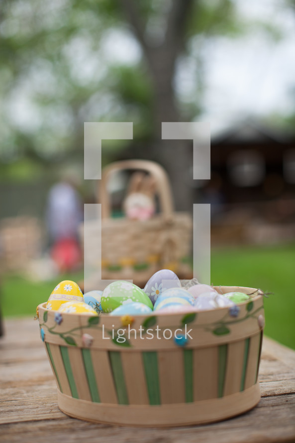 decorated Easter eggs in a basket on a table 