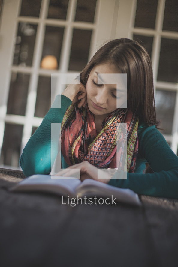 A young woman reading her Bible