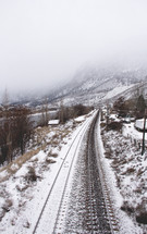 snow covered train tracks 