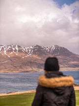 a woman looking out at distant mountains 