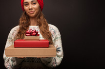 a woman holding gift boxes 